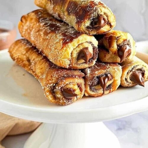 Cuisson des roulés façon pain perdu dans une poêle avec du beurre