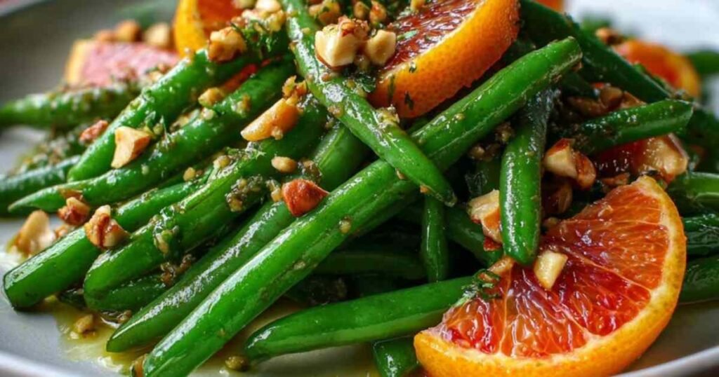Ingrédients pour la recette des haricots verts aux oranges : haricots frais, oranges sanguines, noisettes, ail, parmesan.