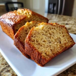 Tranches de pain aux bananes facile et moelleux sur une assiette blanche.