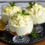 Trois coupes de Crème Mascarpone au Citron individuelles, garnies de chantilly, zeste de citron et menthe.